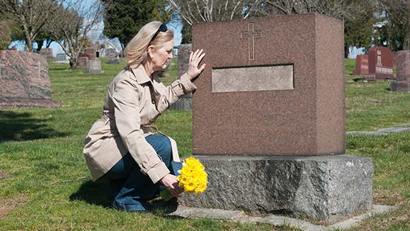 A woman at a grave.