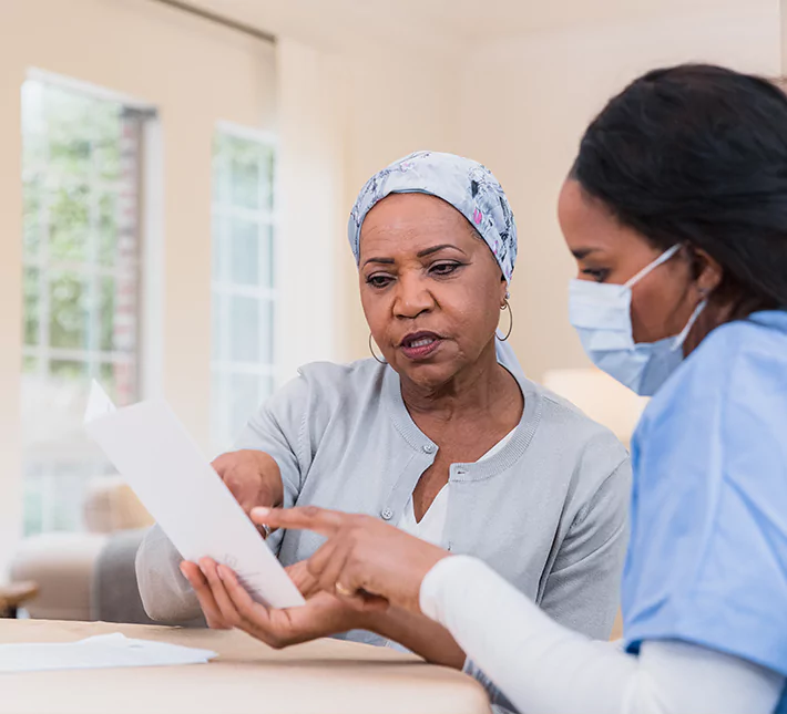 A cancer patient speaking with her nurse.